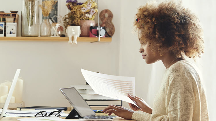 Woman at computer determining what to do with tax refund.