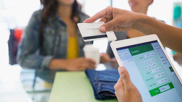 A credit score is displayed on a tablet device.