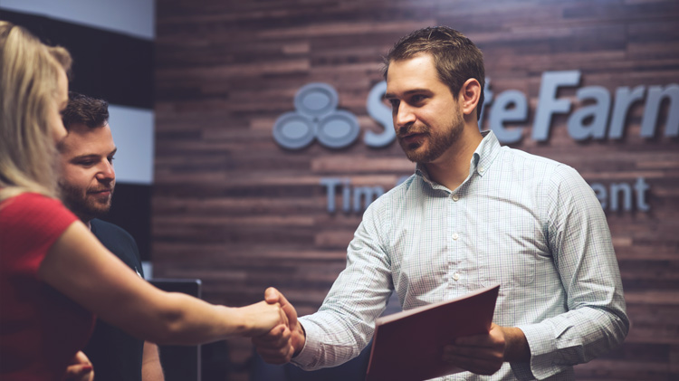 State Farm agent shaking hands with a woman.