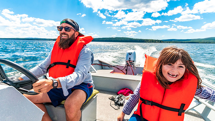 Father and daughter enjoying time together on a boat.