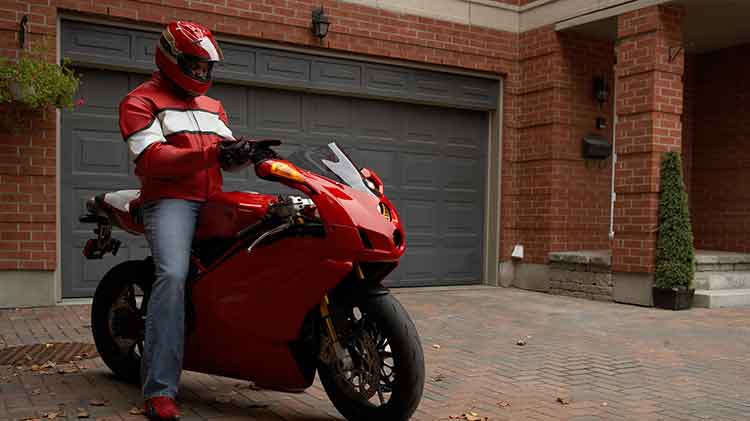 A rider sitting on a red motorcycle