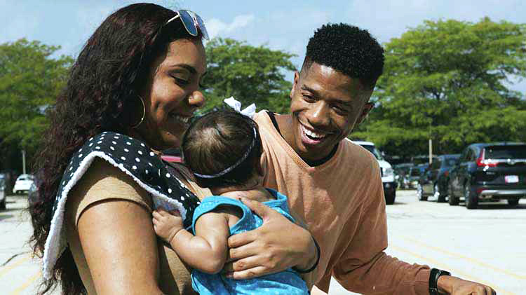 Man and woman holding baby.