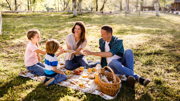 Happy family enjoying a picnic at the park.