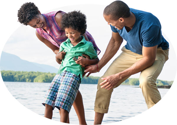 Family of 3 playing together at a lake